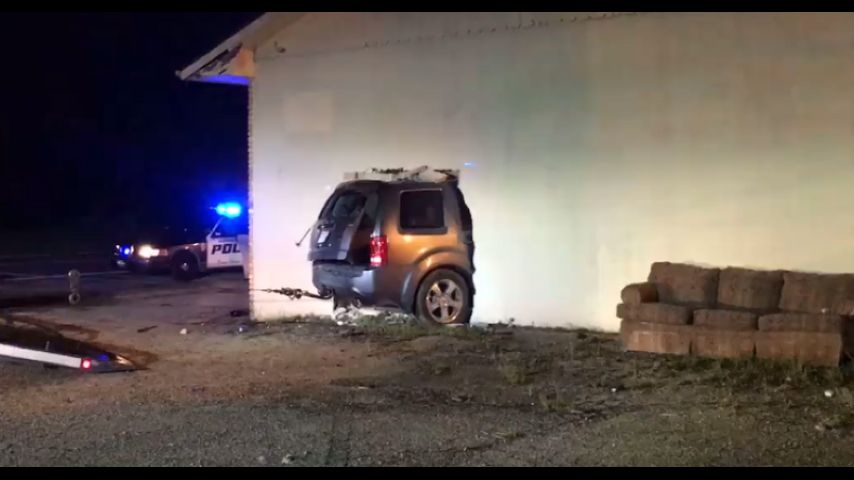 Firefighters rescue trapped driver after vehicle crashes into building overnight