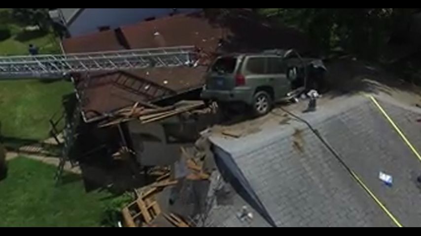 SUV loses control, lands on St. Louis house