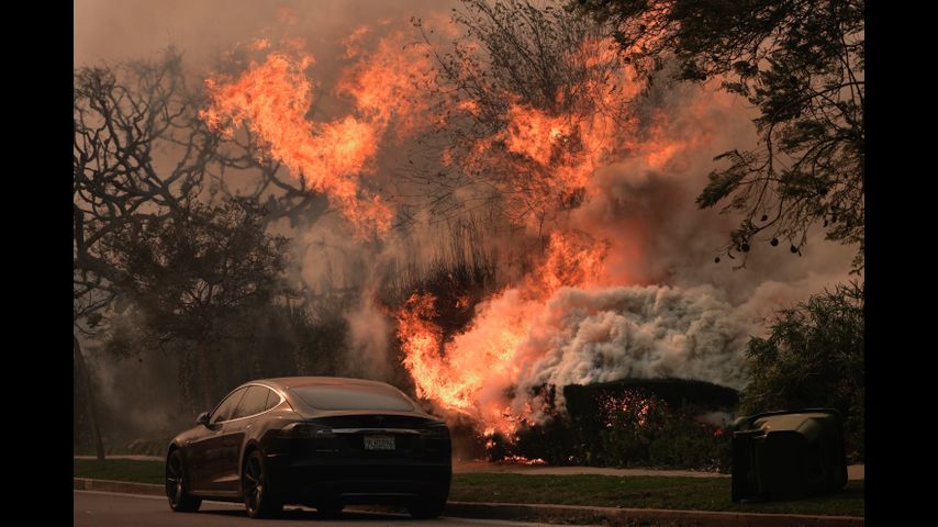 Wildfires burn out of control across Los Angeles area and kill 5 as thousands flee homes