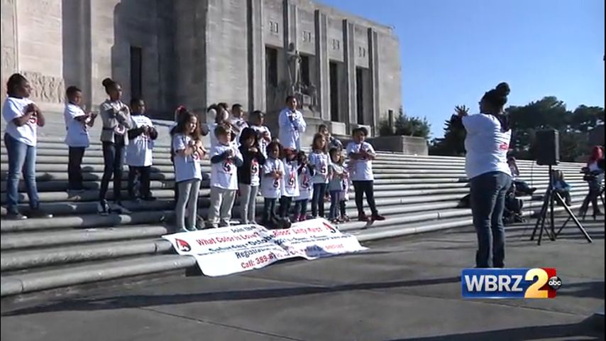 Council members and dozens of people march for unity at the state capitol