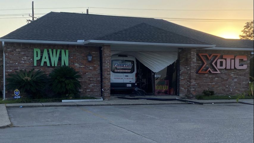 Police investigating after van reportedly crashed into pawn shop