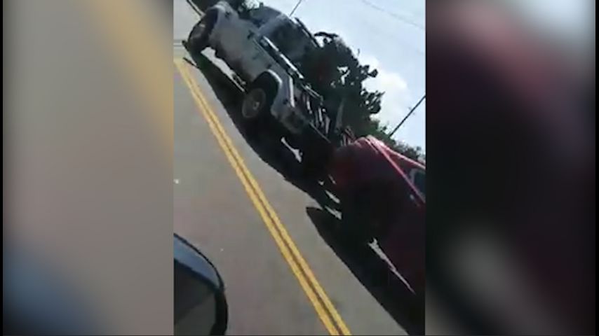 WATCH: Man jumps on tow truck, bashes windows as car is repossessed