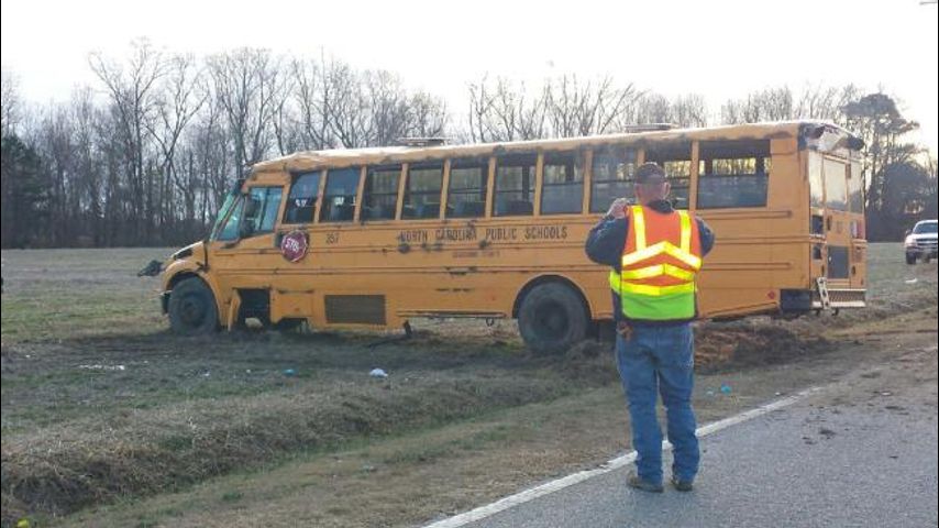 Driver charged after school bus carrying 19 overturns