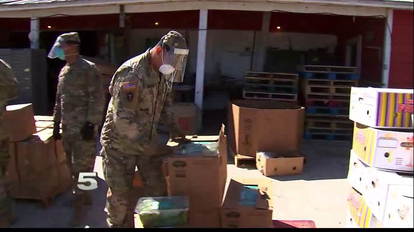 Volunteers and members of Texas Army National Guard distribute food to Valley residents