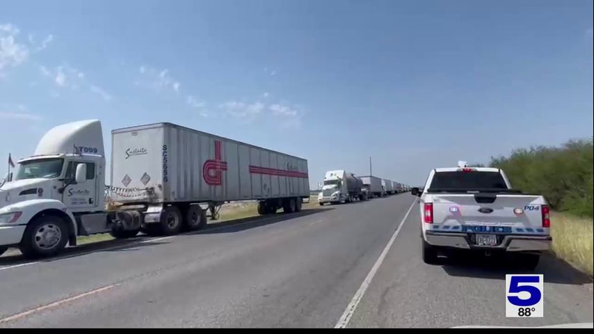 Law enforcement officers conducting traffic at Los Indios International Bridge due to long lines