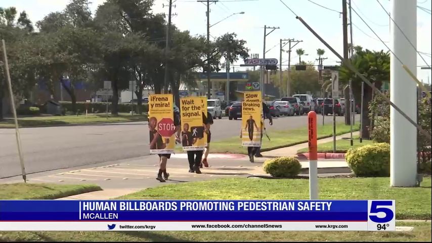 Human billboards promoting pedestrian safety in McAllen